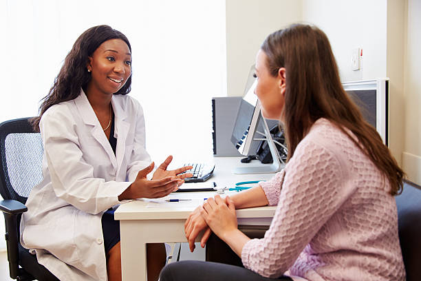 Female Patient Having Consultation With Female Doctor In Office